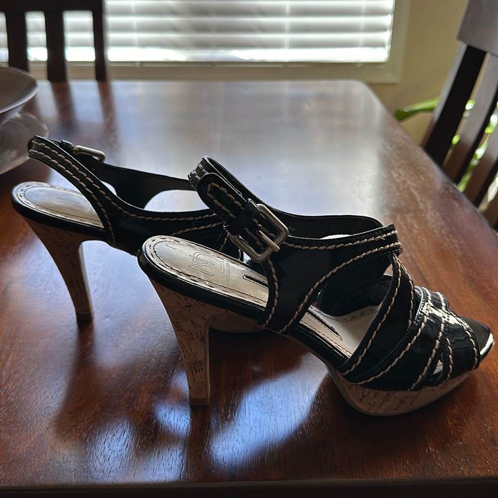 Size 8 1/2. Black with tan stitchings and 3 inch wooden heels.